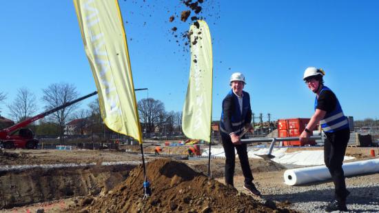Johan Ericsson och Pia Almström tar det första spadtaget för Kävlinge kommuns nya badhus. I bakgrunden förbereds fundament för framtidens simbassänger. Harjagersbadet kommer bli ett badhus på tre våningar med något för alla.