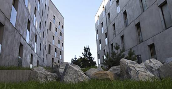 Kvarteret Forskningens grå betonghus fångar upp stenarna i miljön runtomkring och blir en förlängning av berget som de står på.